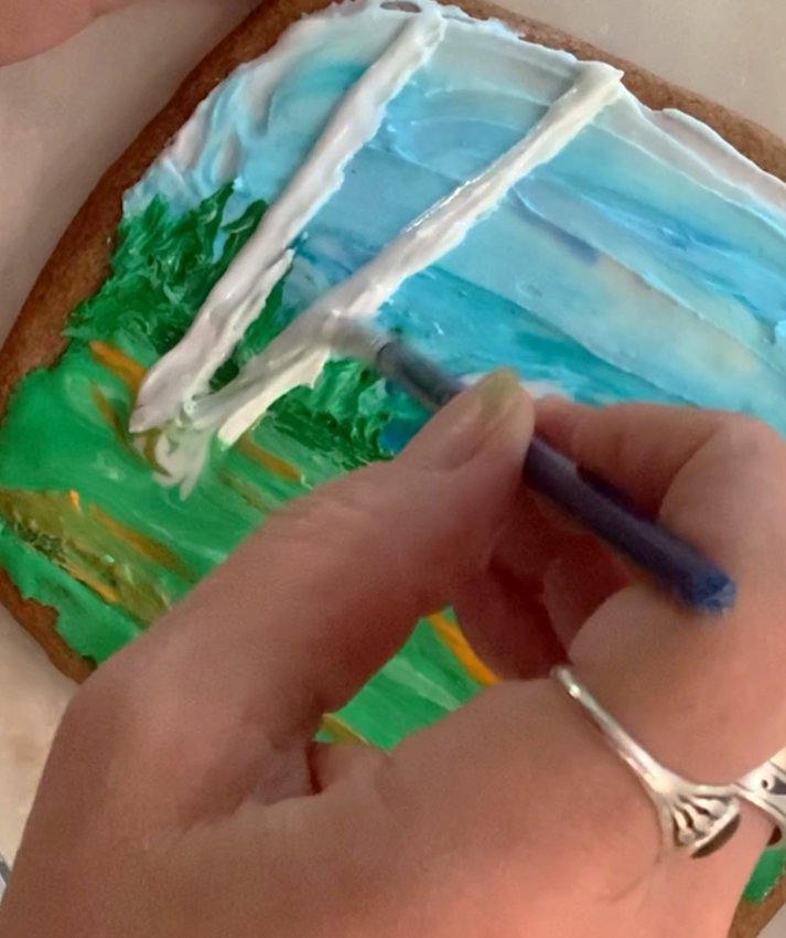 Add birch trees using a small brush and white icing.